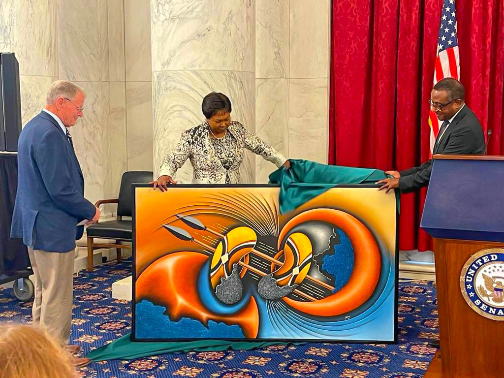 Hon. Vincent Biruta and Rwandan Ambassador Mathilde Mukantabana presented a handmade painting as a farewell gift to Senator Inhofe.